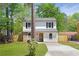 Charming two-story home with stone accents, black shutters and a well-maintained front yard at 6891 Hickory Log Rd, Austell, GA 30168