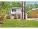 Charming two-story home with stone accents, black shutters and a well-maintained front yard at 6891 Hickory Log Rd, Austell, GA 30168