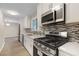 Beautiful kitchen features stainless steel appliances, granite countertops, and stylish tile backsplash at 6891 Hickory Log Rd, Austell, GA 30168