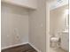 Laundry area leads to updated bathroom with marble accents at 6891 Hickory Log Rd, Austell, GA 30168