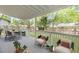 Covered patio with modern furniture offers a relaxing outdoor space and overlooks the backyard at 6891 Hickory Log Rd, Austell, GA 30168