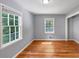 Bedroom featuring hardwood floors, two windows, and gray walls at 1677 Wayland Ne Cir, Brookhaven, GA 30319