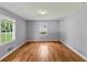 Bedroom featuring hardwood floors, two windows, and gray walls at 1677 Wayland Ne Cir, Brookhaven, GA 30319