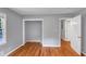 Bright bedroom with hardwood floors, gray walls, closet, and white trim at 1677 Wayland Ne Cir, Brookhaven, GA 30319