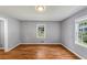 Bedroom featuring hardwood floors, two windows, and gray walls at 1677 Wayland Ne Cir, Brookhaven, GA 30319