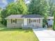 Charming home featuring a well-maintained lawn, gray painted brick foundation and concrete driveway at 1677 Wayland Ne Cir, Brookhaven, GA 30319