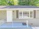 Charming home with a gray painted brick foundation and newly painted white front door at 1677 Wayland Ne Cir, Brookhaven, GA 30319