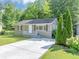 Charming home featuring a well-maintained lawn, gray painted brick foundation and concrete driveway at 1677 Wayland Ne Cir, Brookhaven, GA 30319