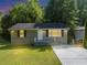 Charming home featuring a well-maintained lawn, gray painted brick foundation and concrete driveway at 1677 Wayland Ne Cir, Brookhaven, GA 30319