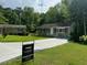 Charming home features a lush front yard, long driveway, and well-maintained exterior at 1677 Wayland Ne Cir, Brookhaven, GA 30319