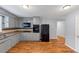 Traditional kitchen featuring gray cabinets, hardwood floors, and modern appliances at 1677 Wayland Ne Cir, Brookhaven, GA 30319