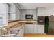 Kitchen featuring gray cabinets, stainless steel sink, and hardwood floors at 1677 Wayland Ne Cir, Brookhaven, GA 30319