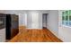 Kitchen featuring hardwood floors, white door, and stainless steel refrigerator at 1677 Wayland Ne Cir, Brookhaven, GA 30319