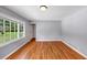 Living room featuring newly refinished hardwood floors, neutral walls and large windows at 1677 Wayland Ne Cir, Brookhaven, GA 30319