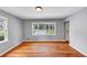 Living room featuring newly refinished hardwood floors, neutral walls and large windows at 1677 Wayland Ne Cir, Brookhaven, GA 30319