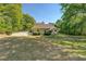 Wide backyard with mature trees offering shade and privacy for a serene outdoor setting at 2611 Fireside Sw Trl, Conyers, GA 30094