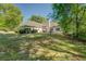 Expansive backyard with mature trees, a patio, and ample space for recreation or relaxation at 2611 Fireside Sw Trl, Conyers, GA 30094