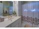 Well-lit bathroom featuring a vanity with a sink, a shower with a decorative curtain, and ample storage at 2611 Fireside Sw Trl, Conyers, GA 30094
