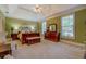 Spacious primary bedroom featuring tray ceilings, neutral carpeting, and a coordinating furniture suite at 2611 Fireside Sw Trl, Conyers, GA 30094