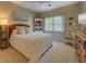 Relaxing bedroom with a ceiling fan, complemented by a bookcase and wicker furnishings, bathed in natural light at 2611 Fireside Sw Trl, Conyers, GA 30094