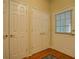 Hallway featuring multiple white doors with brass hardware and hardwood floors at 2611 Fireside Sw Trl, Conyers, GA 30094