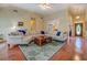 Open living room with hardwood floors, fireplace, and ample seating at 2611 Fireside Sw Trl, Conyers, GA 30094