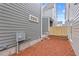 Backyard features a gravel area, a privacy fence, and the gray siding of the house at 3003 Clayton St, Woodstock, GA 30188