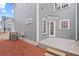 Backyard area with a concrete patio, gray siding, and well maintained landscaping at 3003 Clayton St, Woodstock, GA 30188