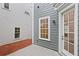 Back patio area with a view of the exterior wall showing a white framed window at 3003 Clayton St, Woodstock, GA 30188