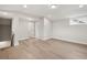 Finished basement with hardwood flooring, ample lighting, and versatile open space at 3003 Clayton St, Woodstock, GA 30188