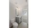 Well-lit bathroom features a modern vanity with a sleek black faucet and a framed mirror at 3003 Clayton St, Woodstock, GA 30188