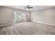 Spacious bedroom with neutral carpet, ceiling fan, and a large bay window at 3003 Clayton St, Woodstock, GA 30188