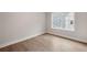 Bright bedroom with light hardwood floors, a large window, and white trim at 3003 Clayton St, Woodstock, GA 30188