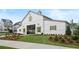 Community clubhouse features a well-manicured lawn and white facade with green shutters in a Primary planned community at 3003 Clayton St, Woodstock, GA 30188