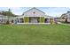 Exterior of community clubhouse with picnic tables, colored chairs and a spacious open-air interior at 3003 Clayton St, Woodstock, GA 30188