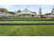 Exterior of community clubhouse and large lawn with retaining wall and open-air interior in a Primary planned community at 3003 Clayton St, Woodstock, GA 30188