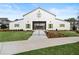 Community clubhouse featuring a well-manicured lawn and white facade with green shutters in a Primary planned community at 3003 Clayton St, Woodstock, GA 30188