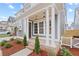 Inviting front porch with classic columns and a brick base, leading to the front door of the home at 3003 Clayton St, Woodstock, GA 30188