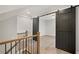 Hallway with black sliding barn doors and a wooden railing at 3003 Clayton St, Woodstock, GA 30188