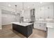 Bright kitchen features a gray island, stainless appliances, and white cabinets at 3003 Clayton St, Woodstock, GA 30188