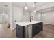 Kitchen island with black cabinets and white countertops; includes a built-in dishwasher at 3003 Clayton St, Woodstock, GA 30188