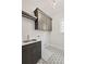 Well-designed laundry room with modern cabinetry, a sink, and stylish patterned flooring at 3003 Clayton St, Woodstock, GA 30188