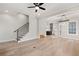 Open-concept living area featuring hardwood floors, a staircase, and seamless integration with the kitchen at 3003 Clayton St, Woodstock, GA 30188