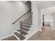 Staircase with hardwood steps, black iron railing, and white risers at 3003 Clayton St, Woodstock, GA 30188