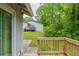 The wooden deck overlooks a large backyard with lots of greenery and a view of the detached garage at 3897 Mcgill Dr, Decatur, GA 30034