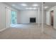 Spacious basement with neutral carpeting, a fireplace, recessed lighting, and access to the backyard at 3897 Mcgill Dr, Decatur, GA 30034