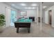 Finished basement with recessed lights, carpet, pool table, fireplace, and access to backyard at 3897 Mcgill Dr, Decatur, GA 30034