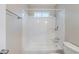 White bathroom featuring shower with plastic surround, and a toilet at 3897 Mcgill Dr, Decatur, GA 30034