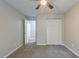 Cozy bedroom with a ceiling fan, carpet floors, and a double door closet at 3897 Mcgill Dr, Decatur, GA 30034