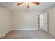 Neutral bedroom featuring carpet floors, a ceiling fan, and an open door to another room at 3897 Mcgill Dr, Decatur, GA 30034